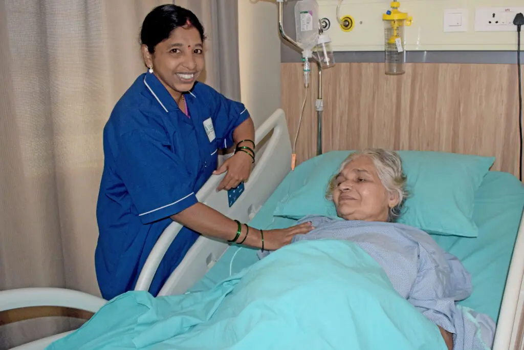 WeCare attendant caring for an elderly patient at home
